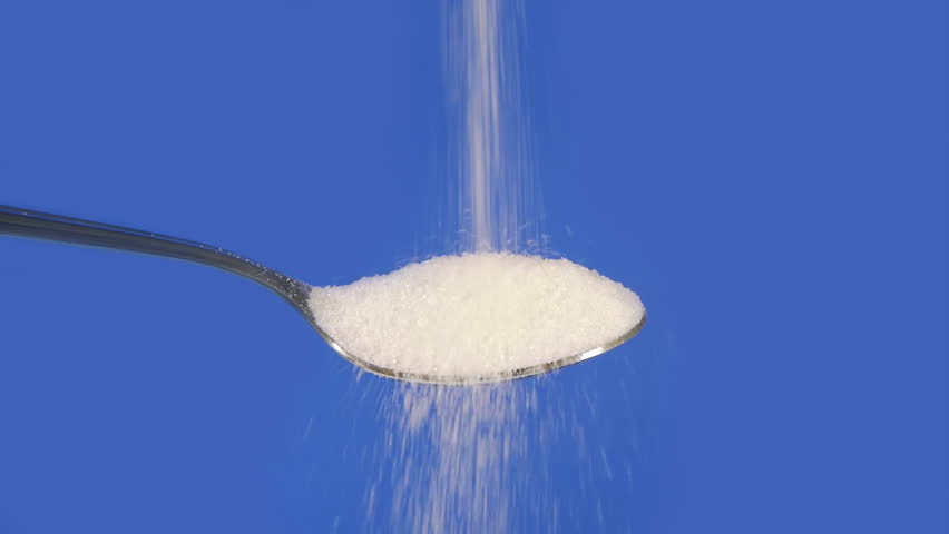 White Cane Sugar Dropped On Spoon. Loops Perfectly.