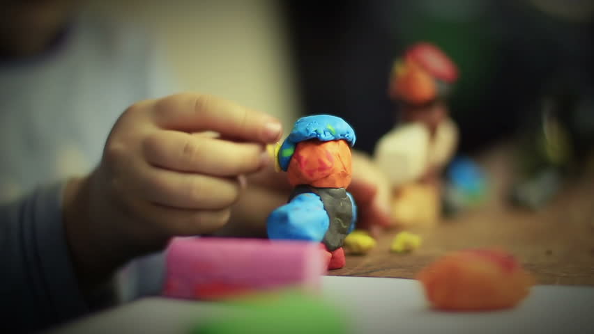 Girl moulding from clay. 1080p.