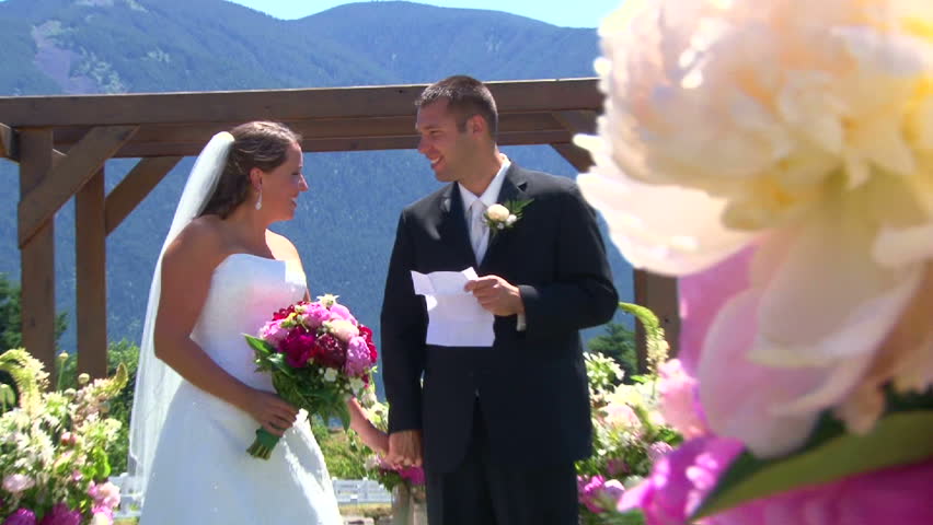 Model released bride and groom stand together at the altar on their wedding day.
