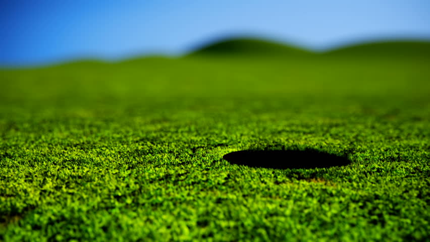 Animation of golf ball falling into a hole.