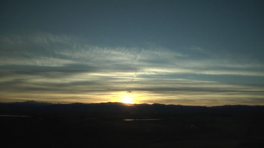 In the Red. A sky with a lot of contrails plus natural cirrus gets painted red at sunset