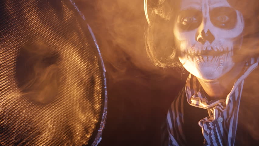 Ghost says Happy Halloween being covered with the magic smoke.