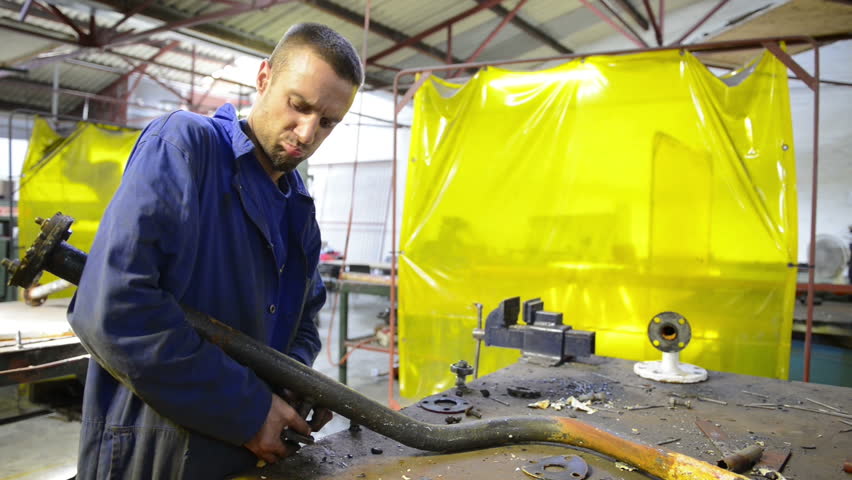 An industrial service repairmen labouring in workshop
