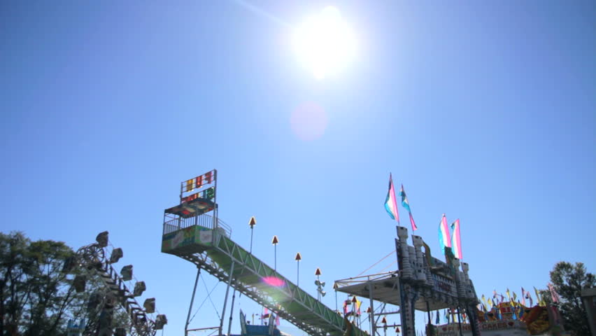 Tilt down of an empty deserted parking lot carnival.