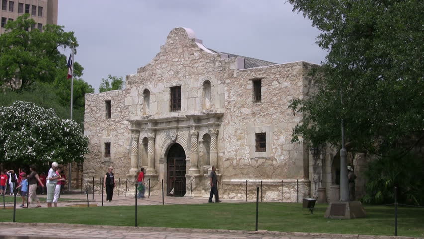 Video from side of front of the Alamo shrine in San Antonio Texas. Texas flag.  Historic famous building Texas independence battle with Mexico. Tourists on vacation. Don Despain of Rekindle Photo