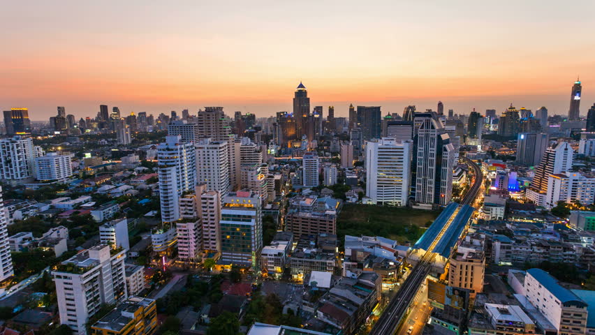 BANGKOK - 30 MARCH: Time lapse view of Bangkok skyline at sunset. Top view of Nana on Sukhumvit road on 30 March 2013 in Bangkok, Thailand. Nana is one of Bangkok red light district.