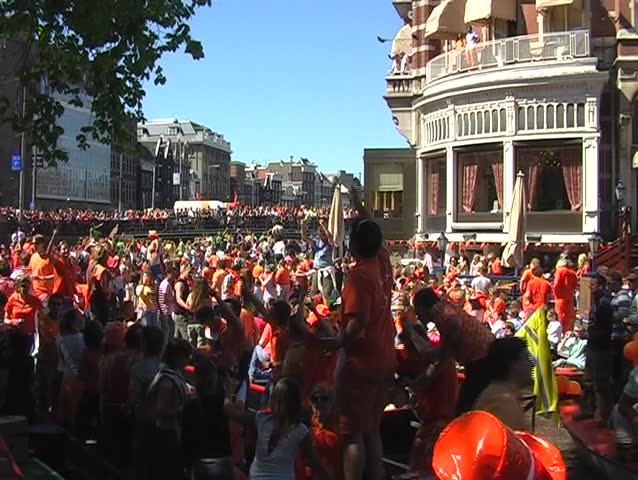 Large dutch crowd on boats during queensday in Amsterdam Netherlands