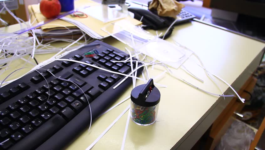 Chaotic office with all sorts of supplies and food. A bad worker, lazy person.