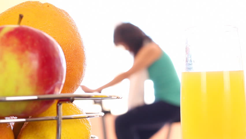 Healthy Life. A man (woman) rides a stationary bike, picks up a fresh juice
