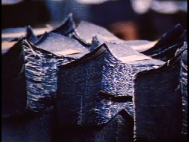 San Francisco, 1970's, close up, pan right, piles of cut denim in pieces