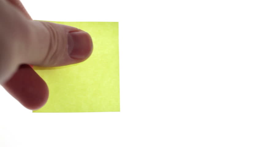 Man's hand put blank yellow sticker isolated on a white background. Ready for your inscription.