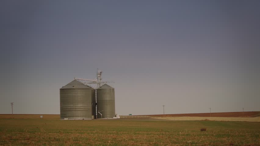 Silos in an open field in Washington state in slow motion
