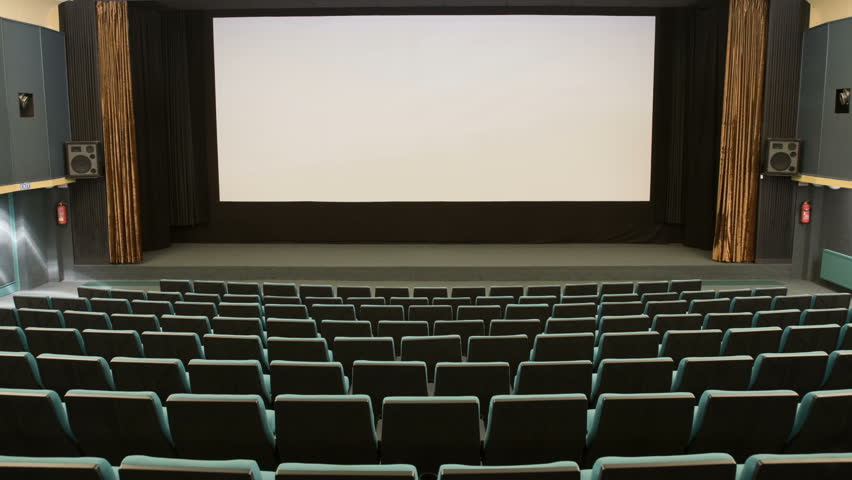 Green cinema auditorium is crowding by people to watch movie performance. Ready for adding your own picture or text.