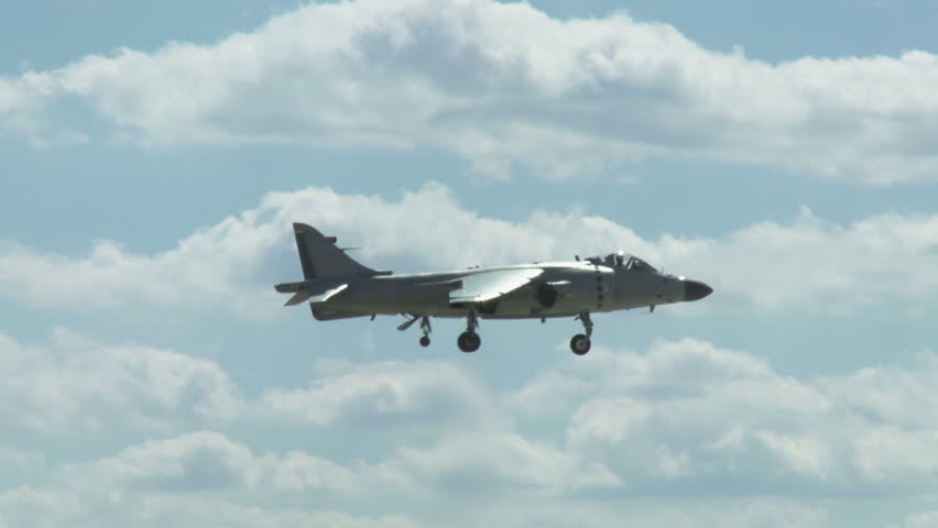 Hawker Harrier Jump Jet hovers and lands vertically on runway into its own jet wash.