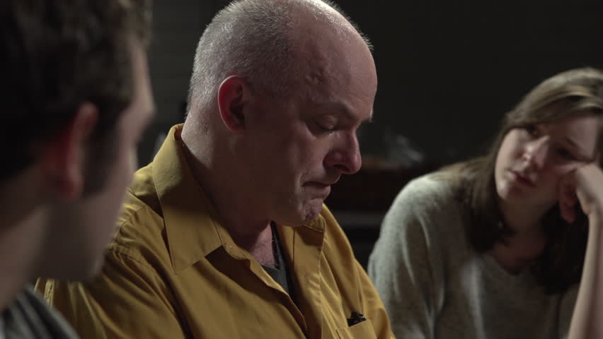 Man crying as he gives his testimony