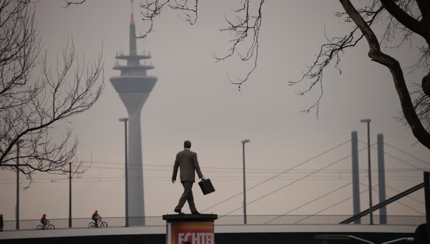 DUSSELDORF, GERMANY â FEBRUARY 28: The Businessman statue by Christoph PÃ¶ggeler is a symbol of the city present status as a powerful economic center.  February 28, 2013,  DÃ¼sseldorf, Germany
