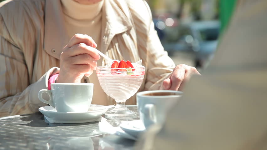 Senior Women Enjoying Dessert At Outdoor Cafe
