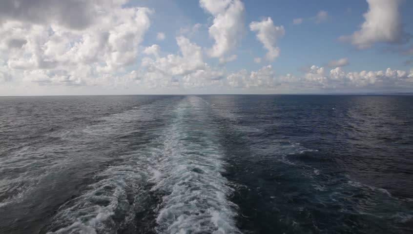 Cruise ship wake view with a sunny horizon. Norwegian Sea