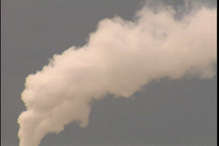 CONVENT, LOUISIANA - CIRCA SEPTEMBER 1999: Camera follows trail of thick, white smoke spewing from smokestack at Convent oil refinery.