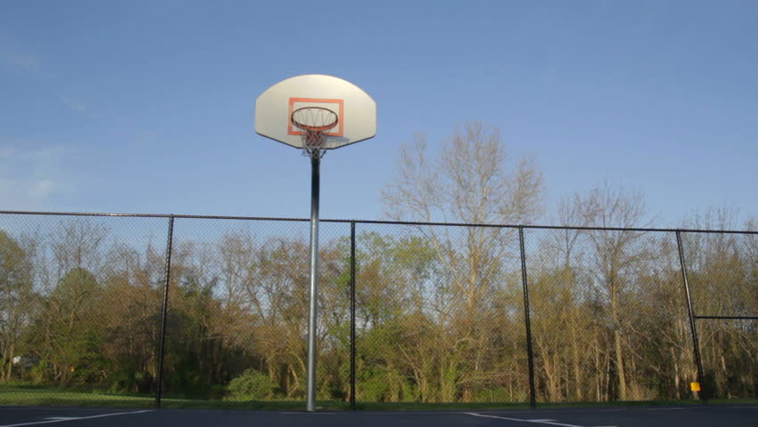 Dolly of a basketball net in an outdoor court.