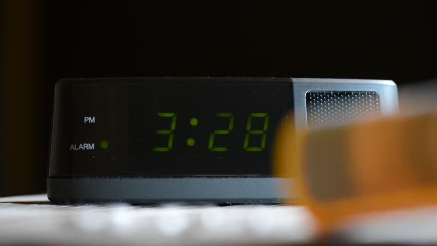 Sleeping Disorder Concept of Rack Focus on Prescription Bottle to Alarm Clock in the early morning