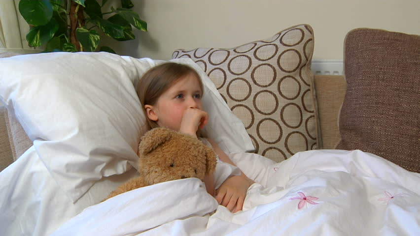 Sick child on sofa - coughing