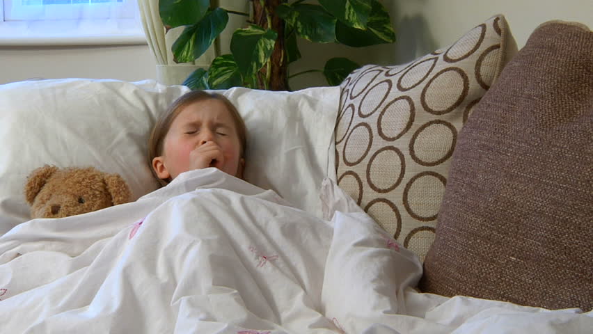 Sick child on sofa - coughing