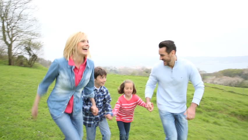 Family running in countryside
