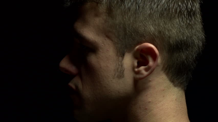 Close up of man's profile in color. Experimental lighting.