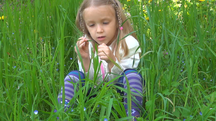 Melancholy Little Girl Singing while Playing with Grass, Child in Park, Children