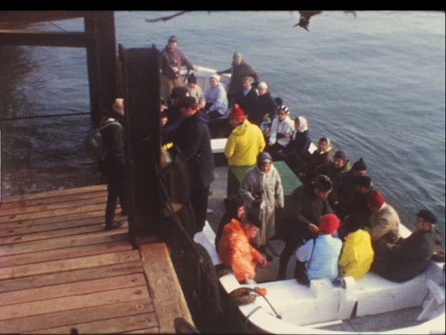 HELGOLAND, GERMANY - CIRCA 1970s: Group of people on boat take trip to Helgoland, Germany circa 1970s. Vintage 8mm film.