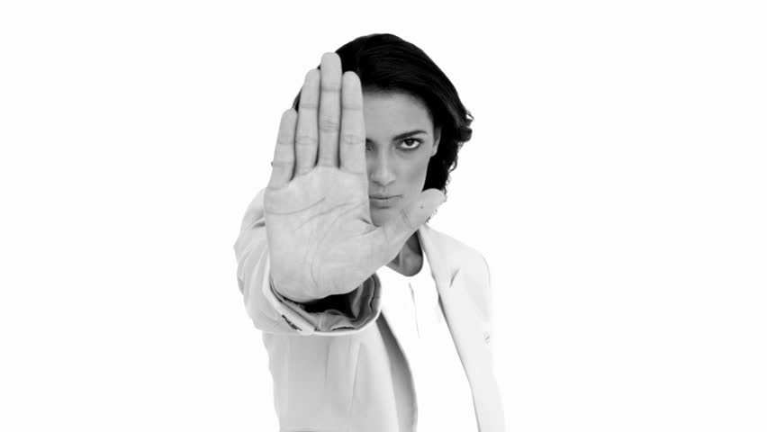 Businesswoman telling you to halt in black and white in slow motion