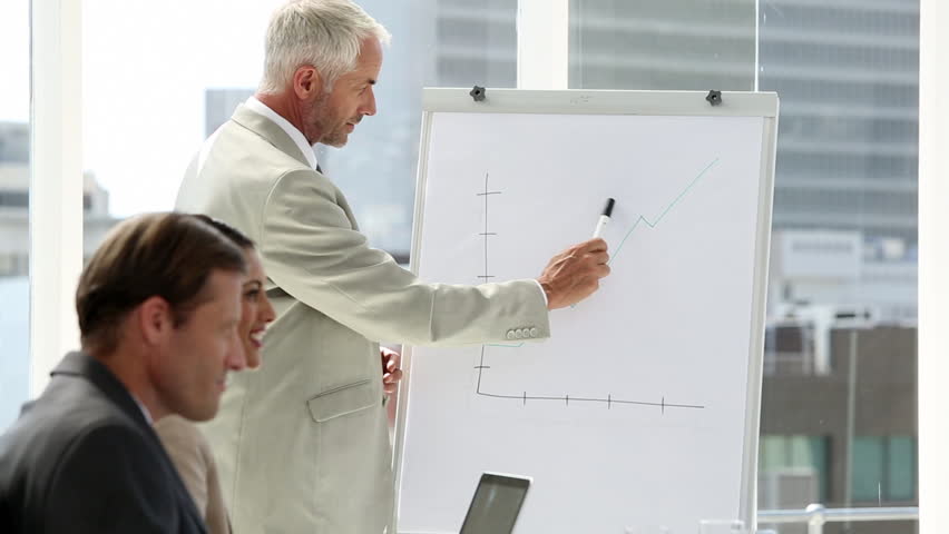 Businessman presenting to the team in the boardroom