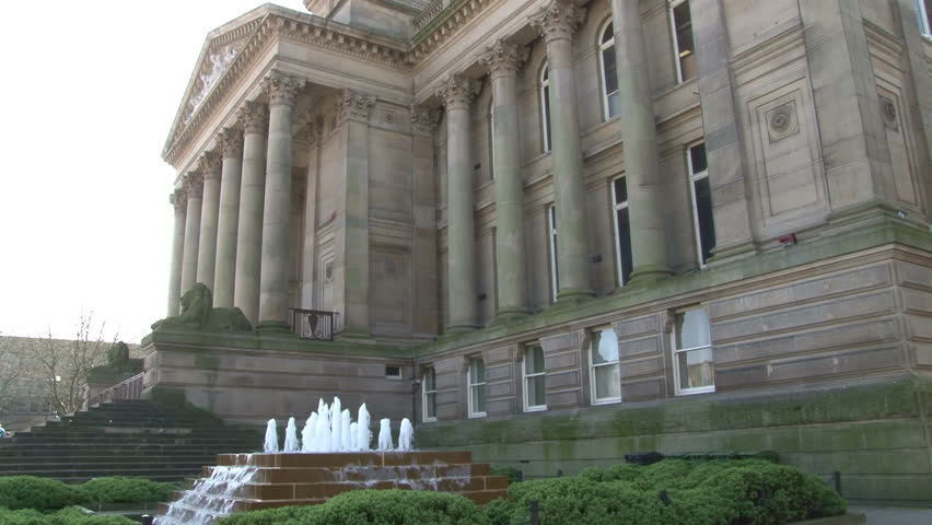 Water feature outside a grand neoclassical civic building.