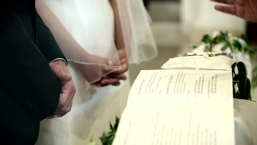 A priest blessing newlyweds.