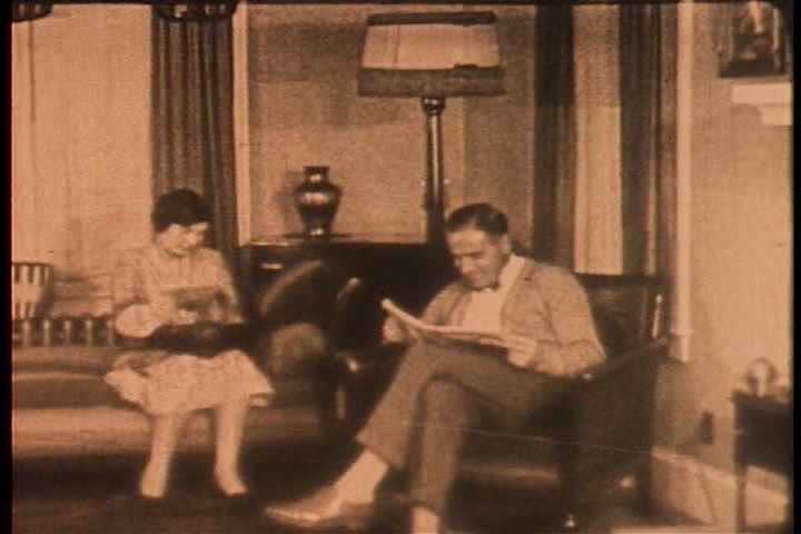1920s - A home movie style shots circa 1915 of a happy family at home.