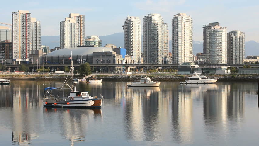 False Creek Boats, Vancouver Cityscape. An early morning view of downtown Vancouver's skyline reflected in the still waters of False Creek. British Columbia, Canada.
