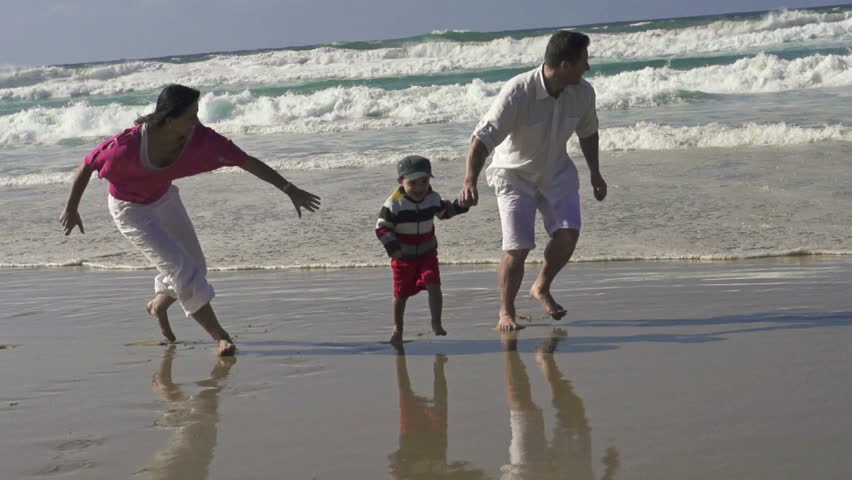 Happy family having fun on the beach, super slow motion, shot at 240fps
