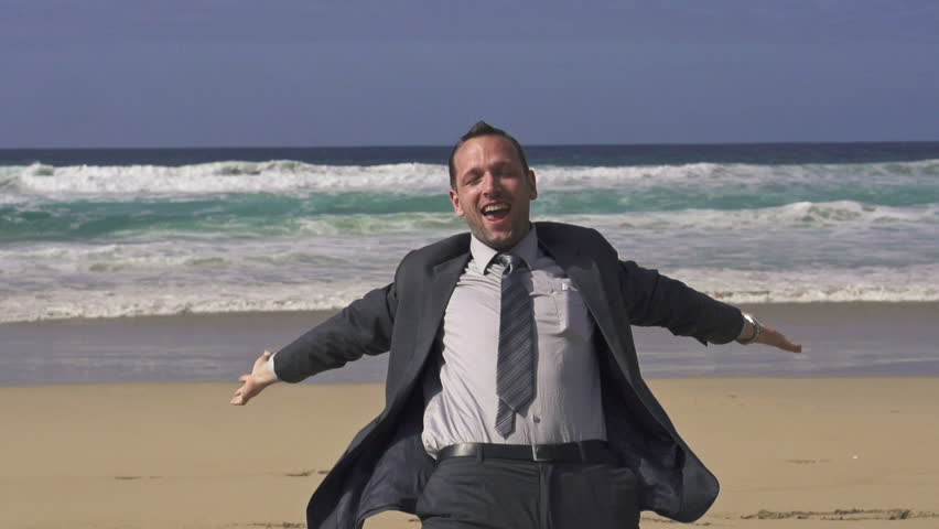 Excited businessman screaming by the sea, super slow motion, shot at 240fps
