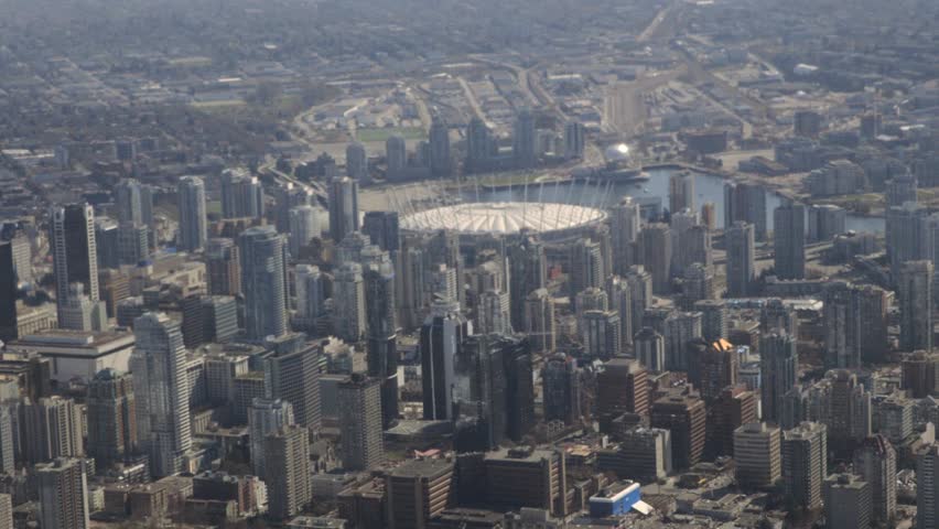 An aerial view of downtown Vancouver, British Columbia - including the harbor and BC Place, shot from a seaplane.