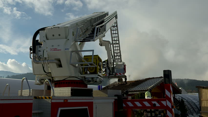 SouthTyrol, ITALY - CIRCA 2012: Fire brigade extinguish fire, garden house burns.
