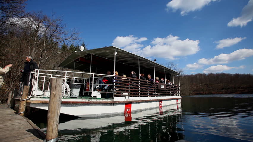 PLITVICE - APRIL 6. Passengers boarding boat to cross lake on April 6, 2010  in Plitvice National Park, Croatia. The park was inscribed on UNESCO World Heritage List in 1979 for it's natural beauty.