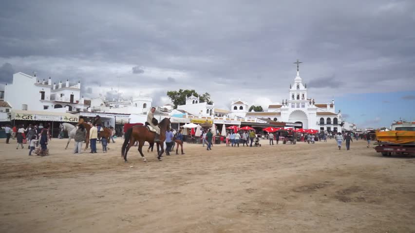 El ROCIO, ANDALUCIA, SPAIN - MAY 19: Pilgrims, people attend to the Sanctuario de Nuestra Senora de El Rocio in one of the most famous religious pilgrimage of Spain. May 19, 2013 in el Rocio, Spain