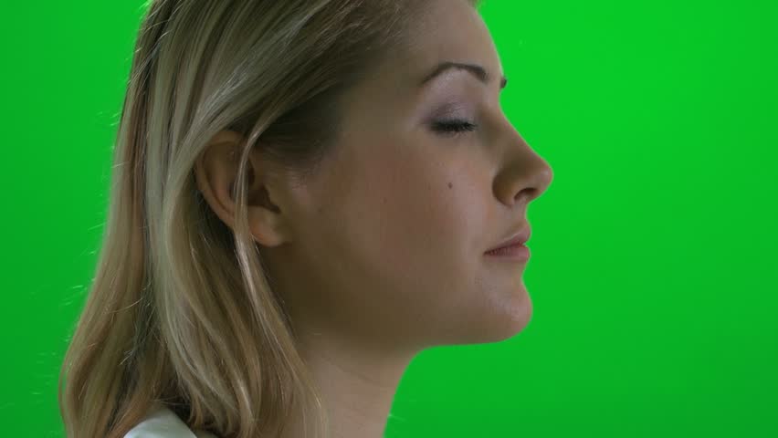 close up of blond women isolated against green screen