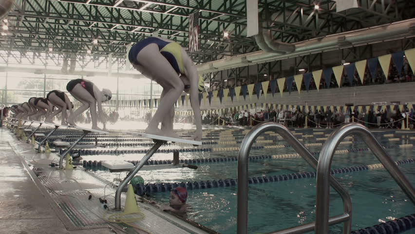 Swimmers diving in the water at a swim meet. (Slow Motion) Clearwater Florida. Location: The Long Center