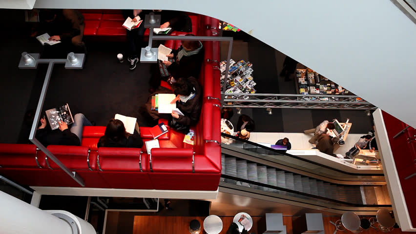 People reading books in sophisticated bookstore with staircase with background / HD1080 / 30fps 
