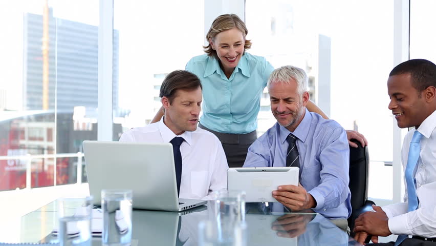 Group of business people using laptop and tablet computer during a meeting