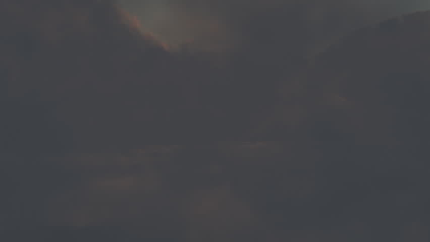 Seamless loop of flight through the clouds at sunset