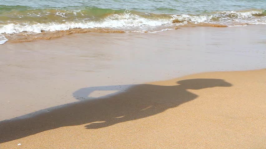man's shadow. man watching the sea