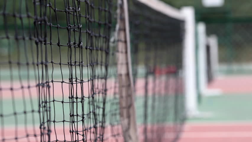 Tennis ball flying into the net